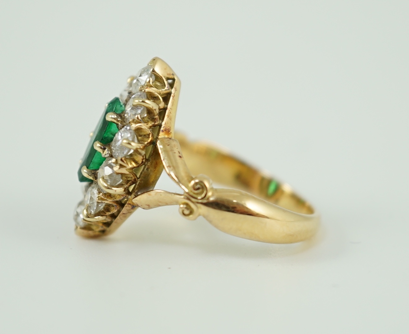 A Victorian style gold, emerald and diamond set marquise cluster shaped ring